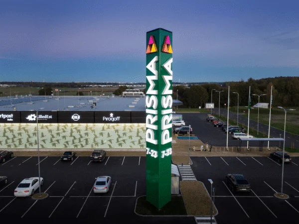 Prisma valgustatud roheline reklaampost kaupluse parklas õhtuhämaruses